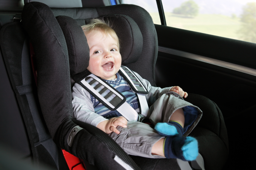 Baby boy in a child safety car seat